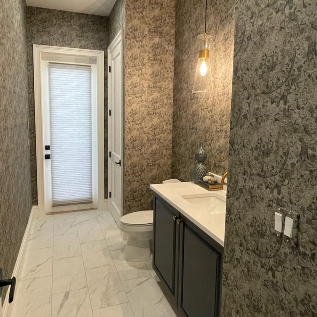 Elegant bathroom with designer wallpaper and modern amenities by Steele Design Solutions in Naples FL.
