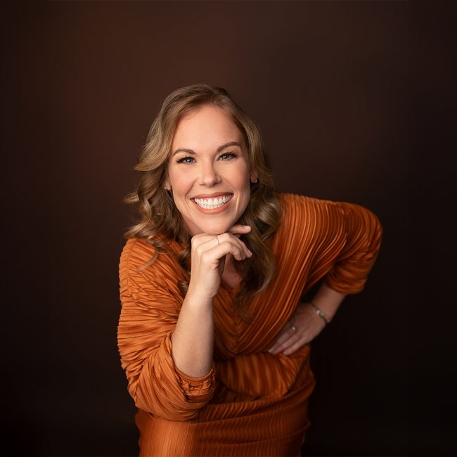 Nikki Steele, owner of Steele Design Solutions, smiling warmly in a beautifully designed interior space.