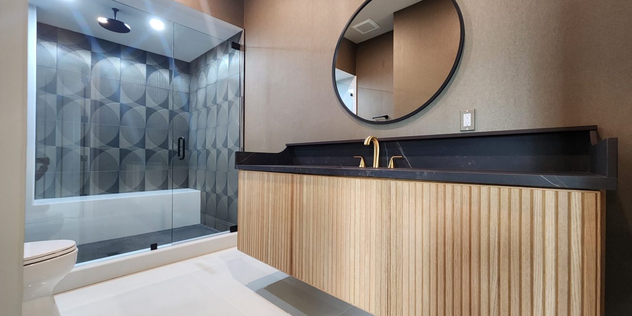 Small bathroom renovation in Naples, FL featuring space-saving design, custom storage, and bright lighting by Steele Design Solutions.